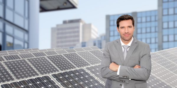 Business man with solar panels in background