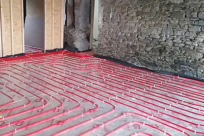 Underfloor heating pipework laid out before the floor is finished
