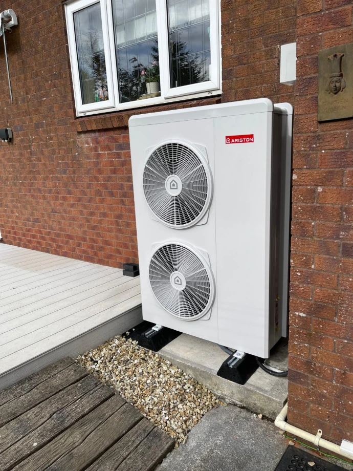 Air-source heat pump installed beside a home by Thermal Earth