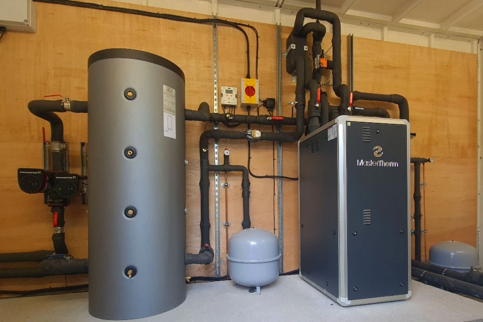 Completed heat-pump plant room with MasterTherm equipment, cylinder and insulated pipework
