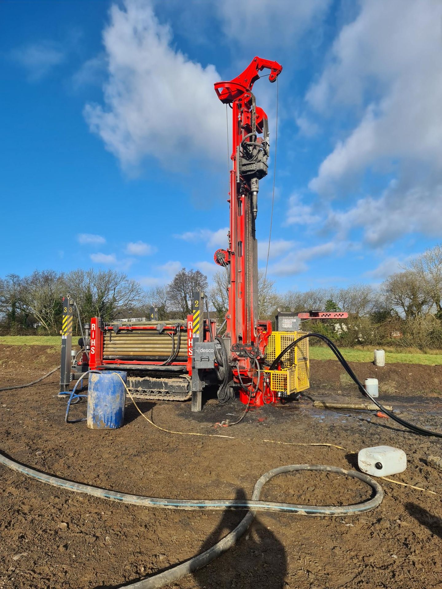 Diagram showing multiple houses connected to a shared ground loop borehole system